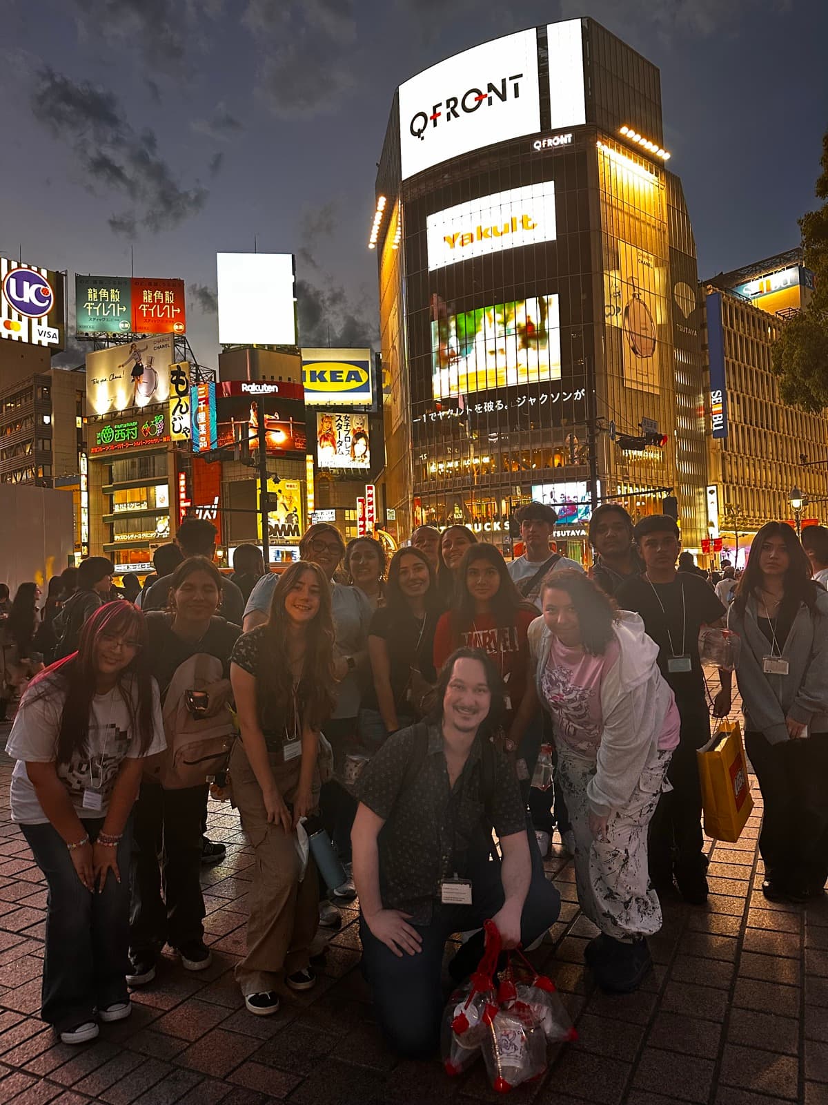 Tour group at the Shibuya scramble crossing at night